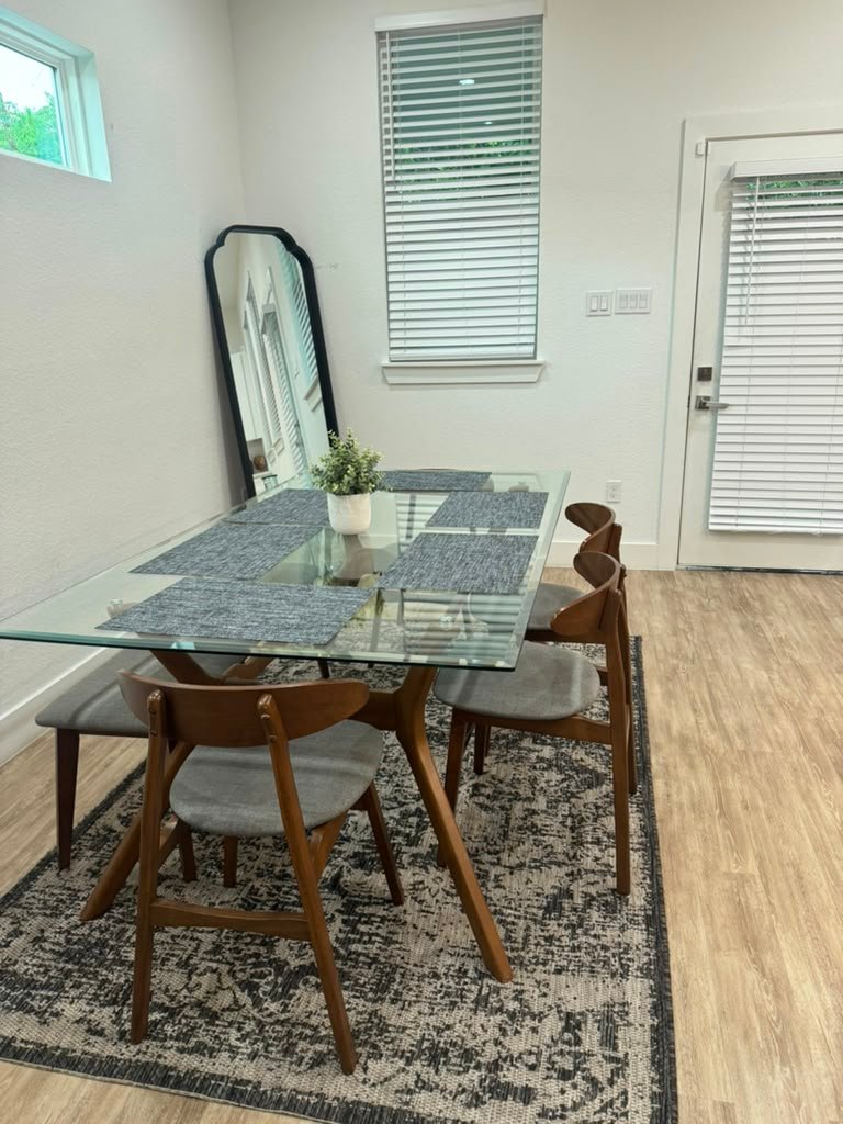 Tidy dining room with glass table cleaned by Zulma Cleaning Services