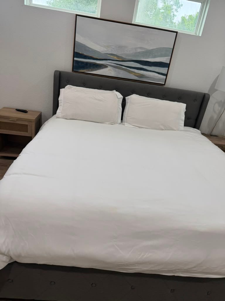 Neatly made bedroom cleaned by Zulma Cleaning Services